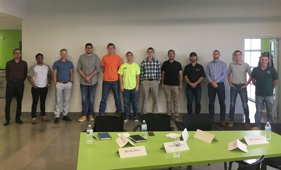 Smiling group of Cadillac Asphalt employees indoors